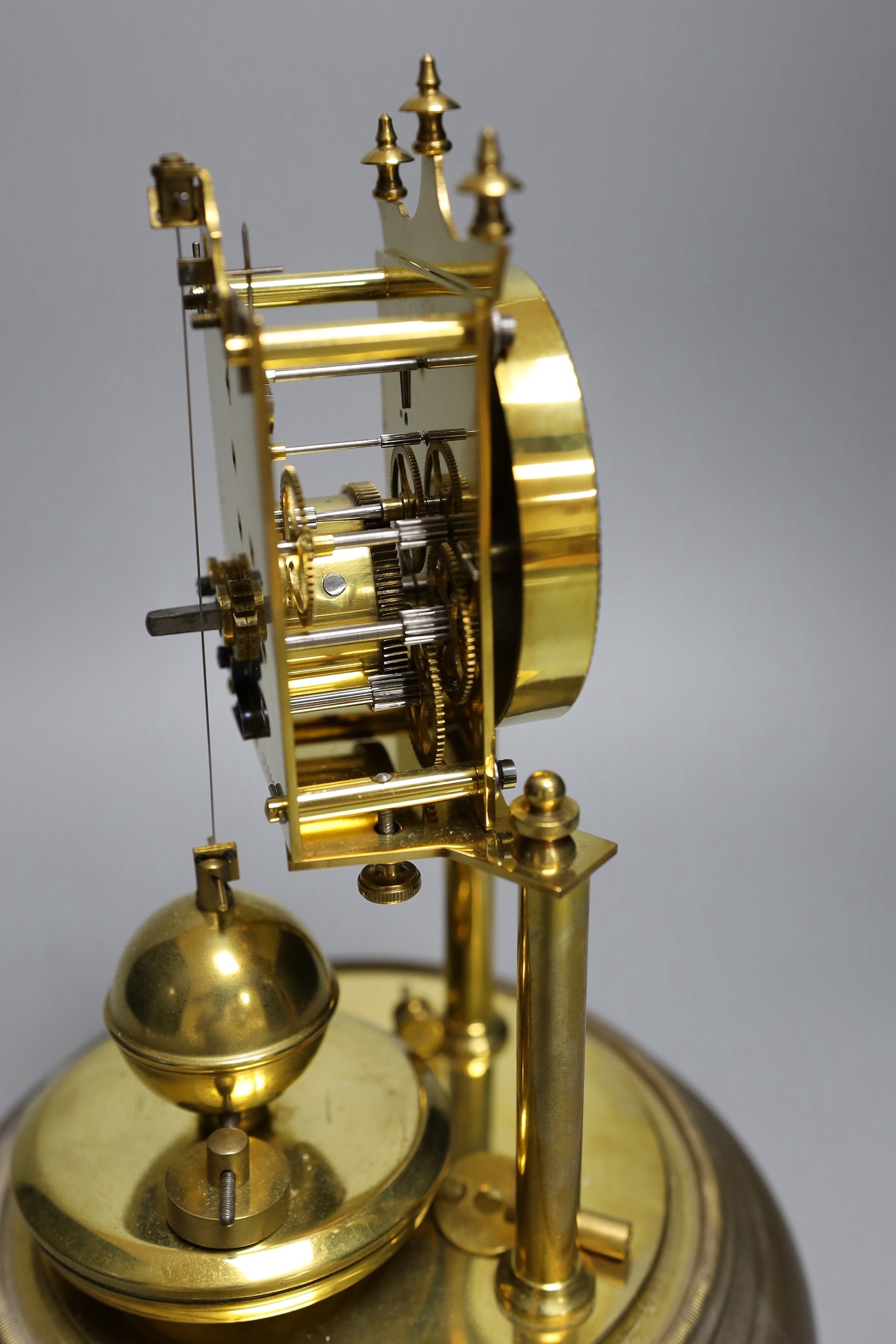 A German 400 day brass mantel timepiece, under a glass dome 29cm total height